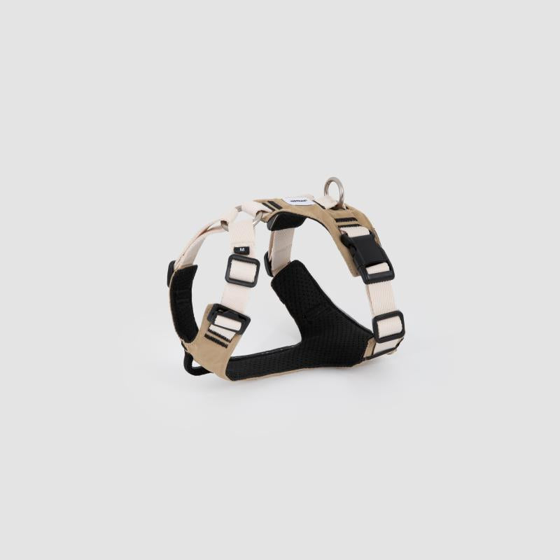 Beige adjustable dog harness with soft padding and metal D-ring, product display
