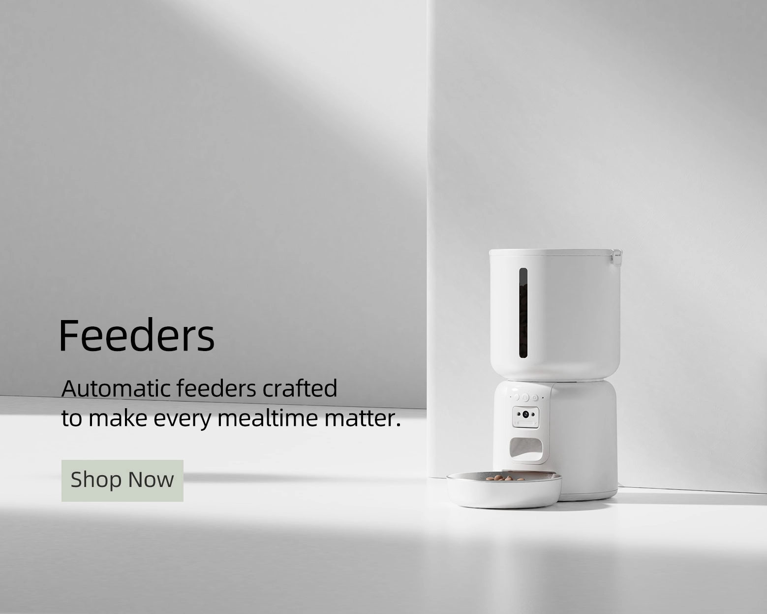 White automatic feeder on a white surface with promotional text and a 'Shop Now' button.