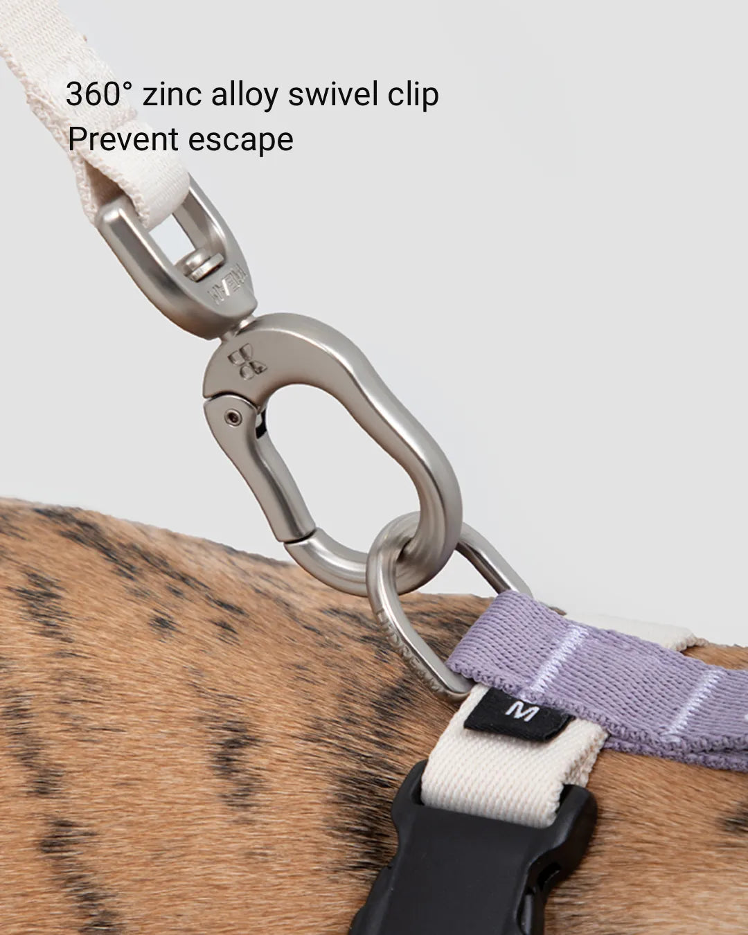 Close-up of 360-degree zinc alloy swivel clip attached to dog harness for secure connection